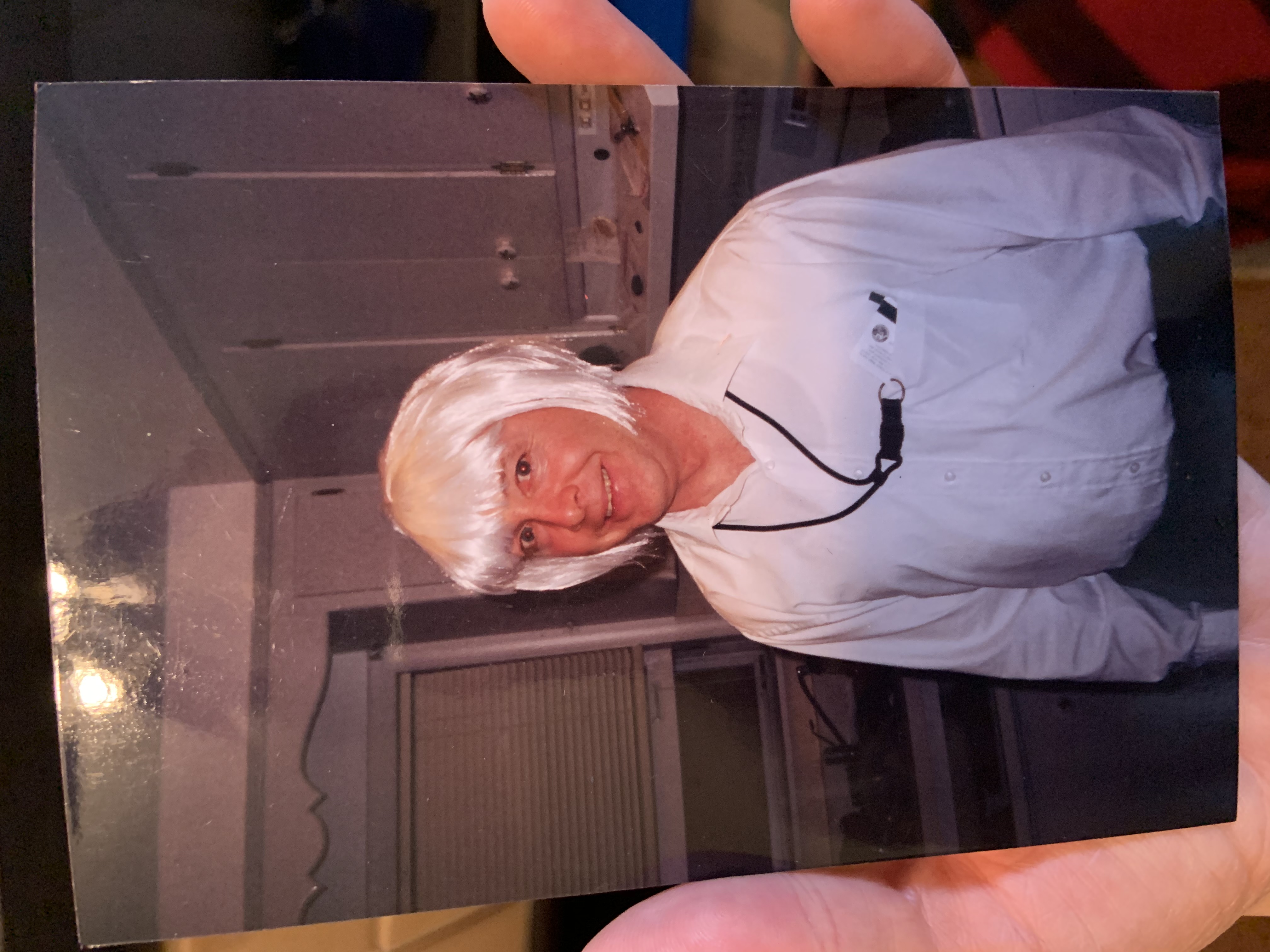 Man in a white wig in a kitchen