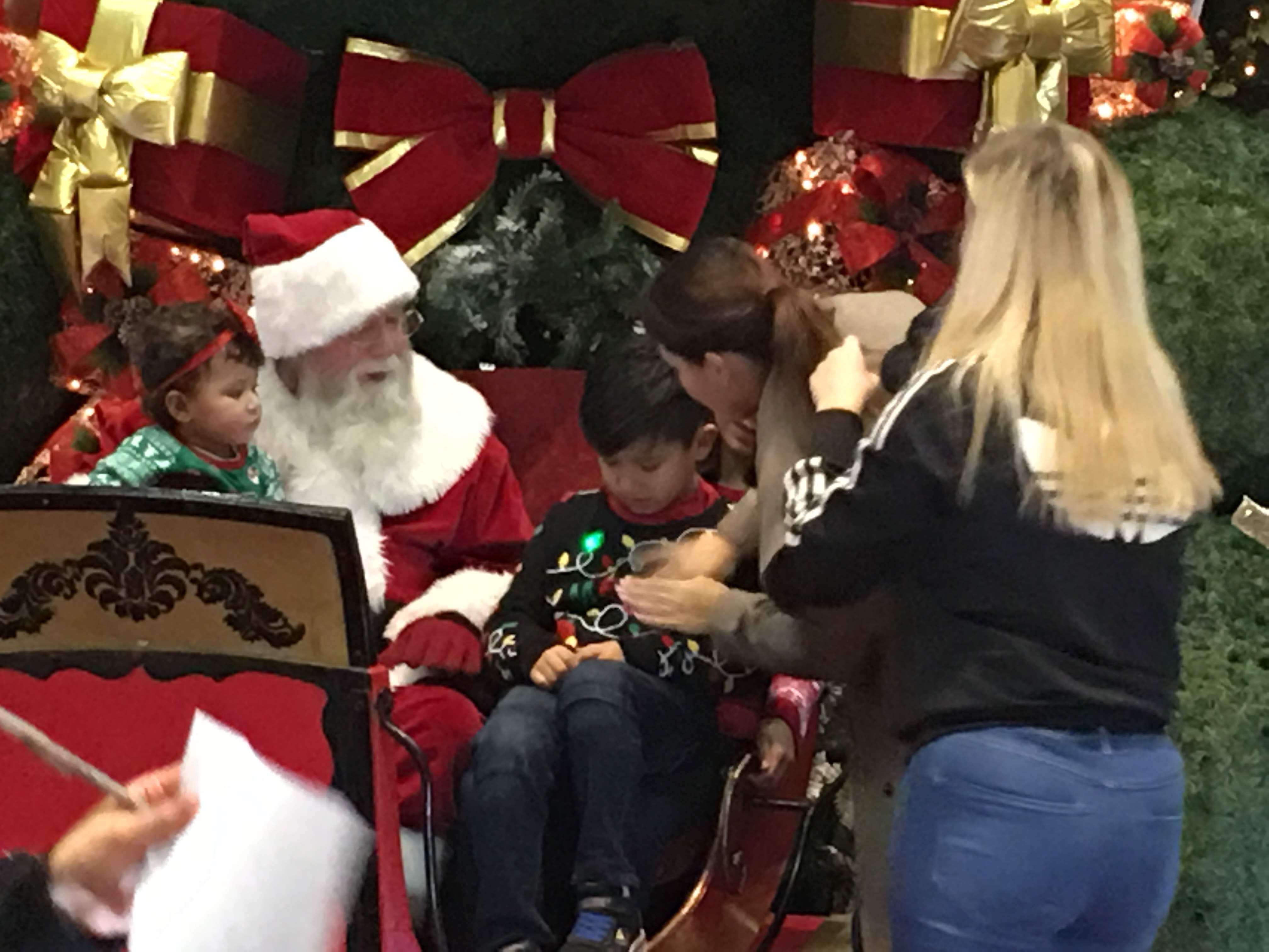 Tom as Santa greeting children at a mall event