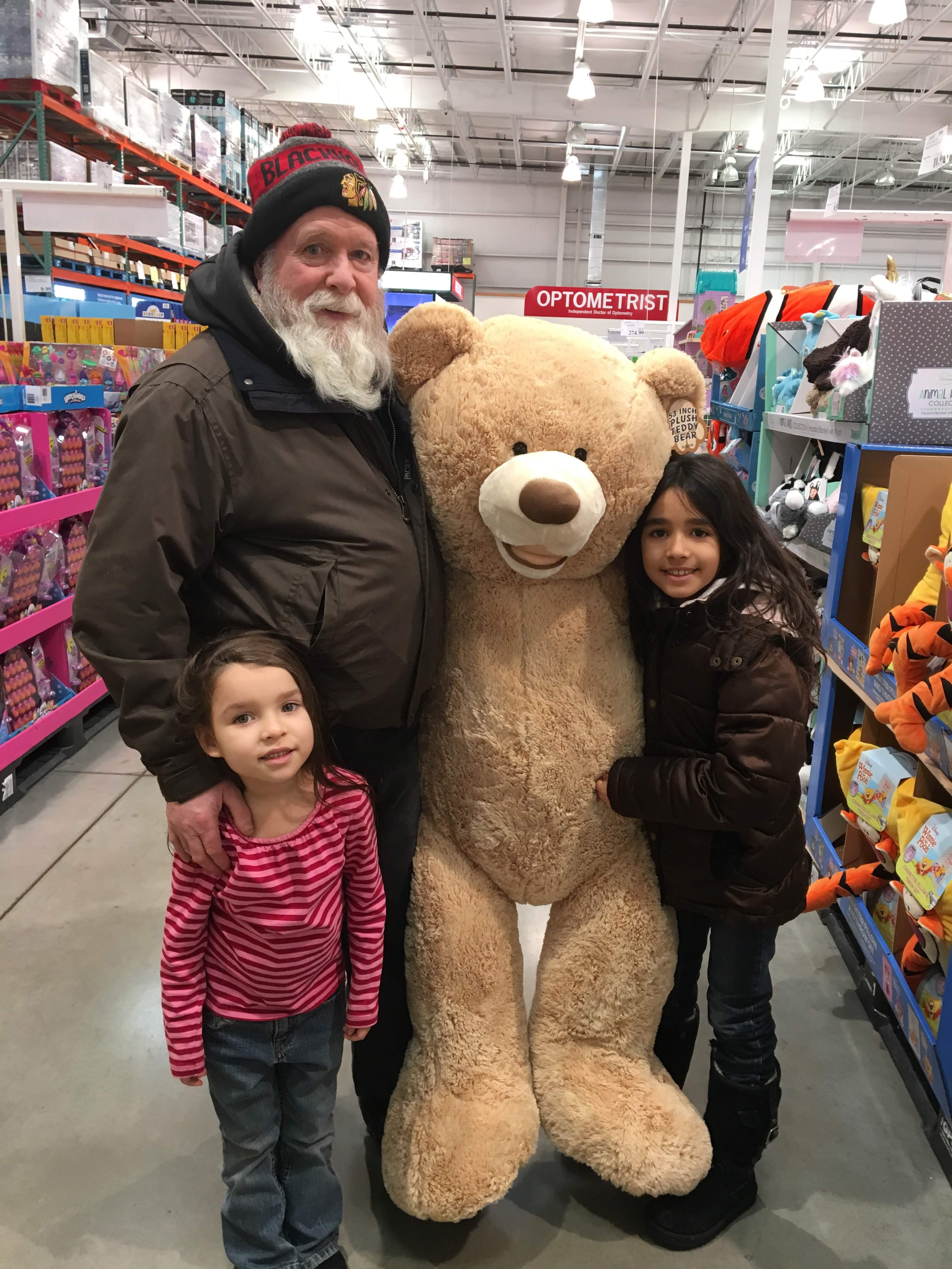 Tom with two granddaughters and a giant teddy bear at Costco