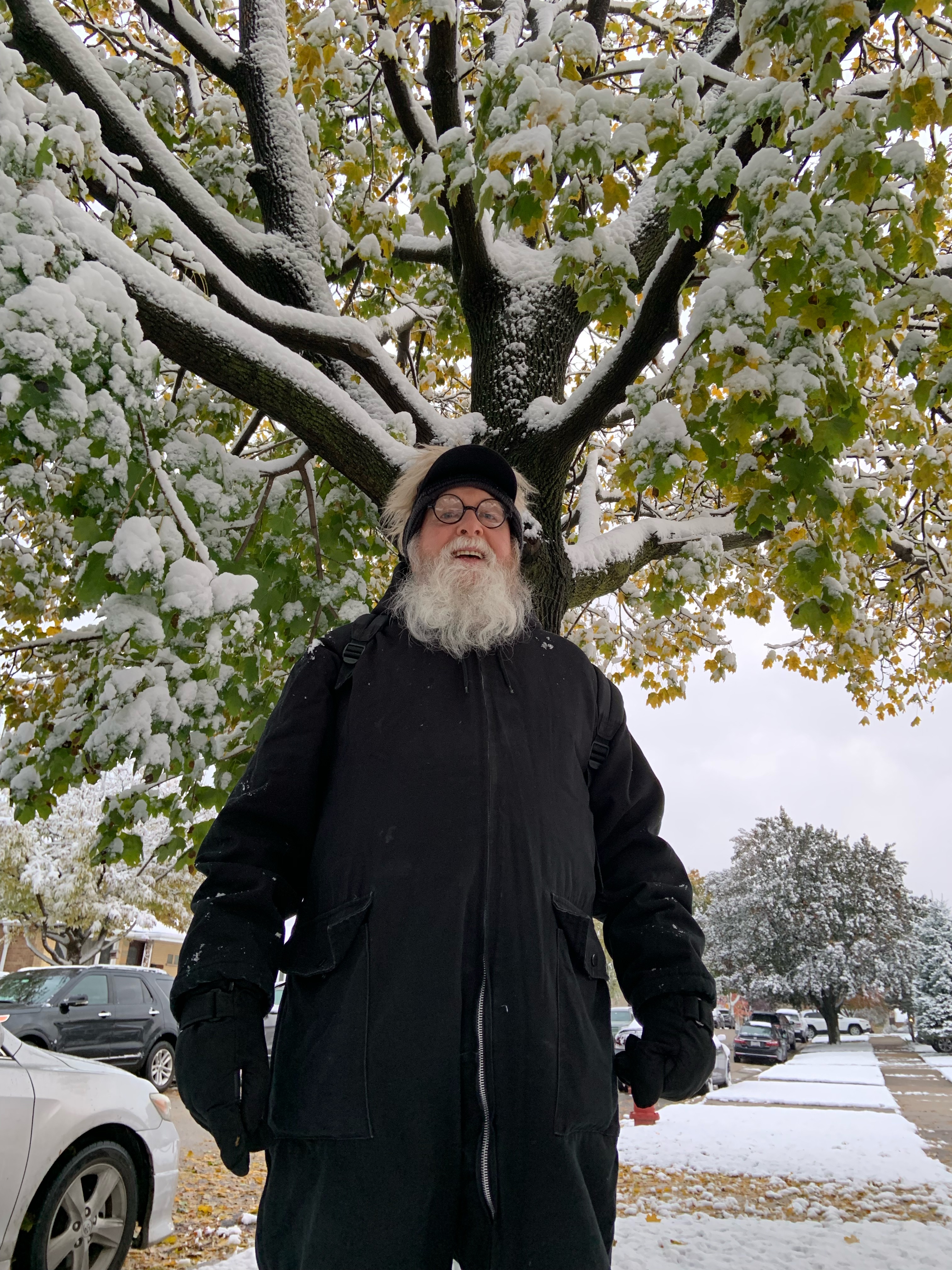 Tom outdoors in a black hat and coat